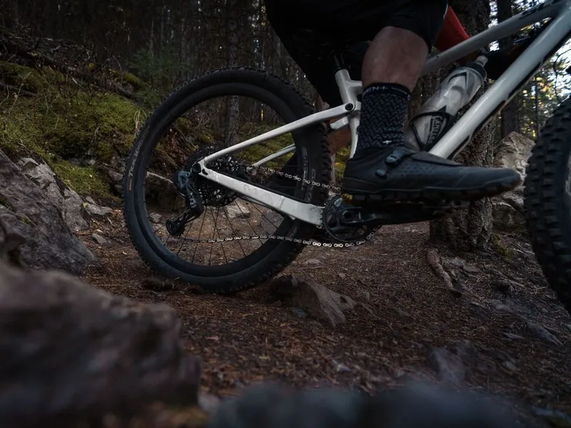 Mountain bike fit. Man going down a trail on a mountain bike