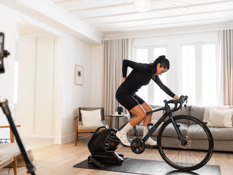 women riding indoors on trainer with back pain